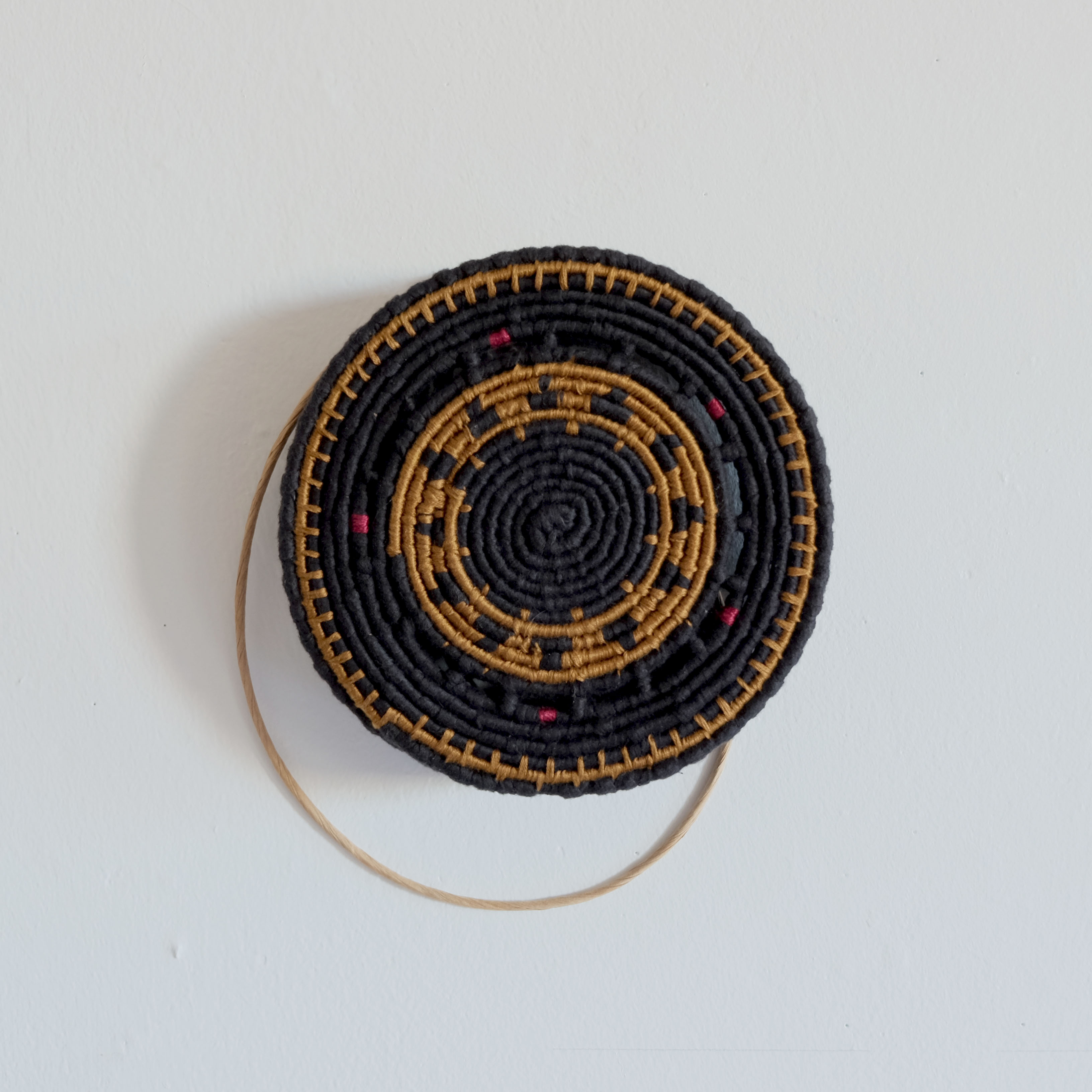 The base of a coiled hat, made with fibre rush and floss. (2017)